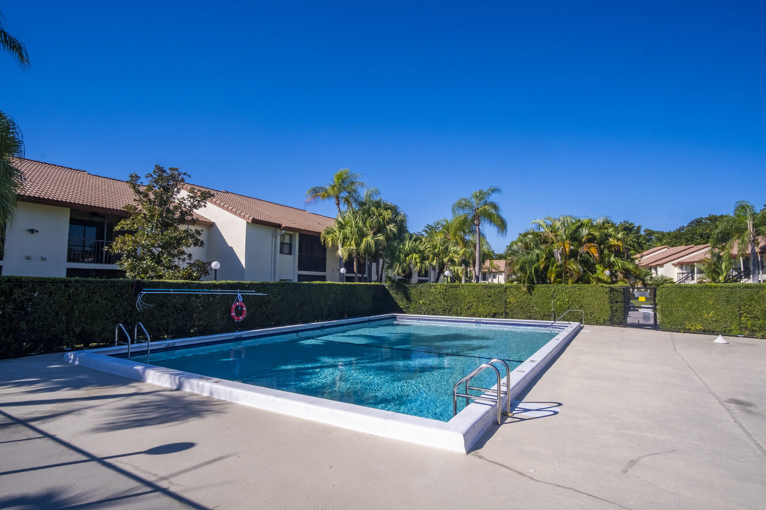 22076 Palms Way, Unit 203 Boca Raton, FL 33433 - Photo 24 of 25 a view of swimming pool with a yard
