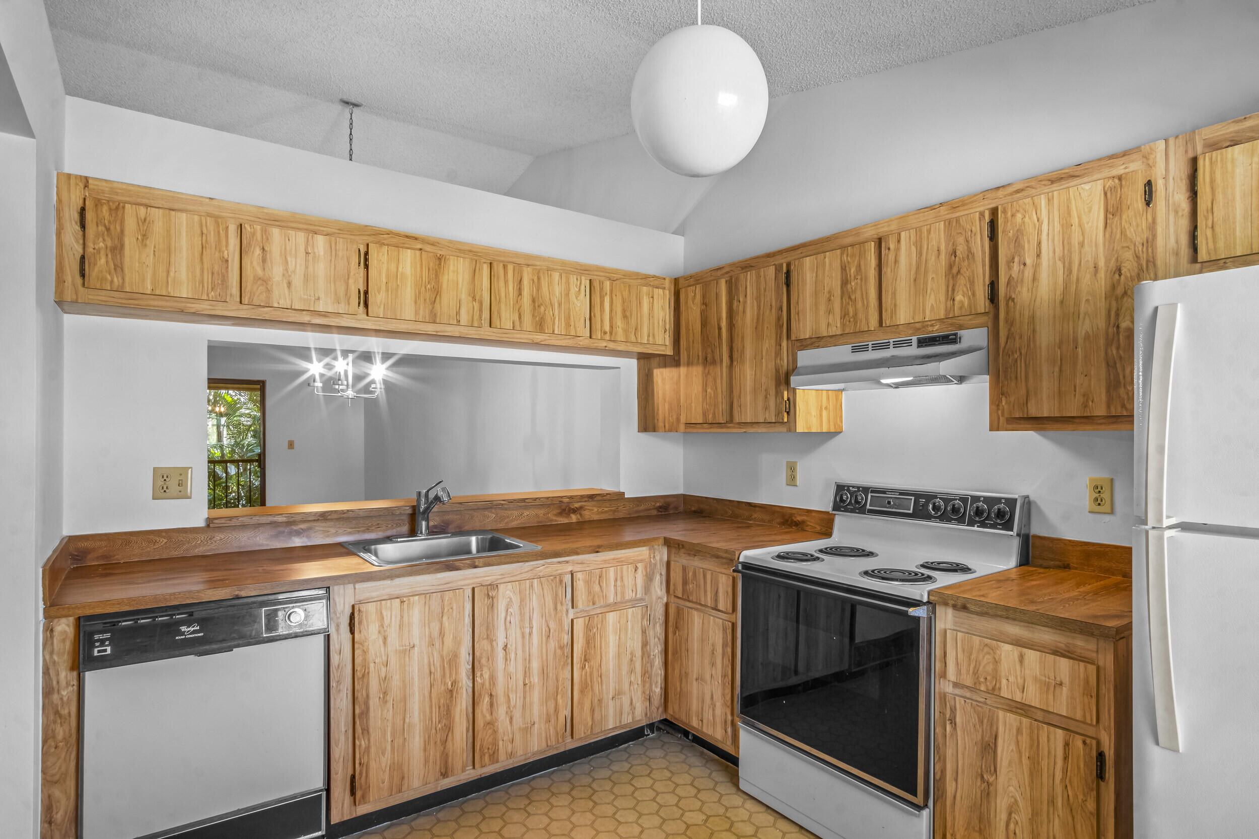 22076 Palms Way, Unit 203 Boca Raton, FL 33433 - Photo 6 of 25 a kitchen with stainless steel appliances granite countertop a sink a stove and a refrigerator