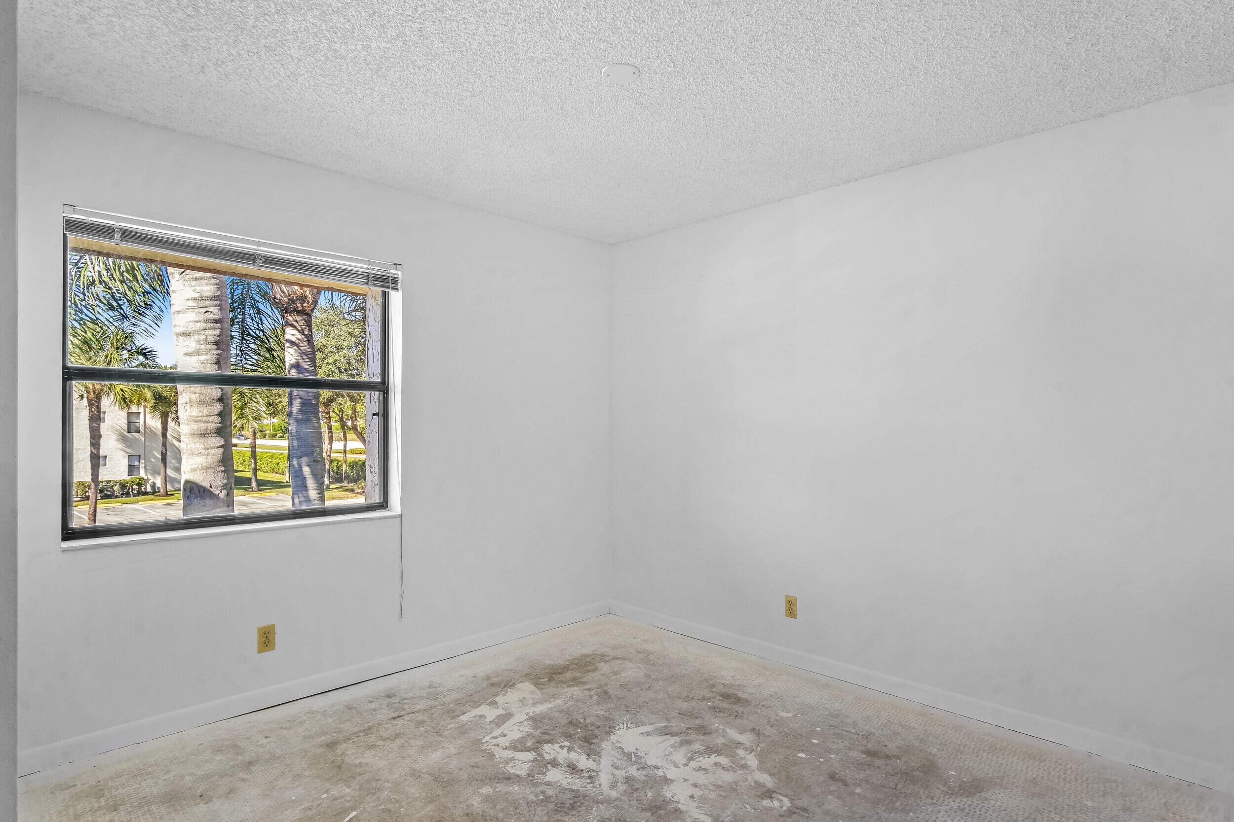 22076 Palms Way, Unit 203 Boca Raton, FL 33433 - Photo 9 of 25 an empty room with a window