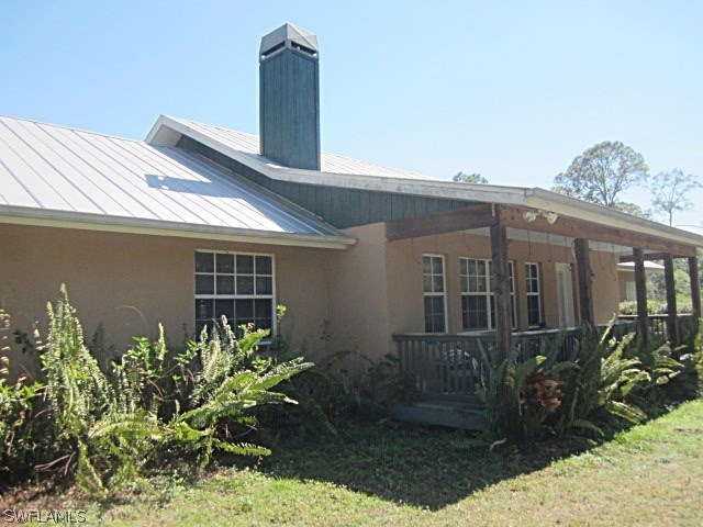 12931 Shawnee Road Fort Myers, FL 33913 - Photo 1 of 19 a front view of a house with garden
