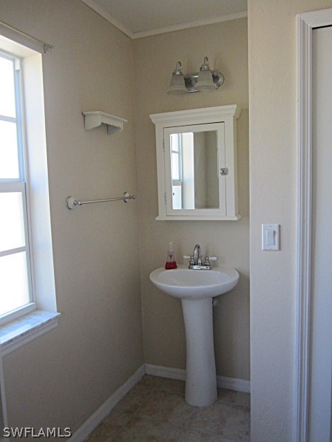 12931 Shawnee Road Fort Myers, FL 33913 - Photo 12 of 19 a bathroom with a sink a mirror and a window