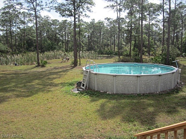 12931 Shawnee Road Fort Myers, FL 33913 - Photo 17 of 19 a view of a backyard with a small pool and outdoor seating