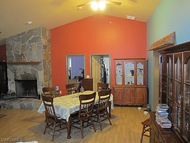 12931 Shawnee Road Fort Myers, FL 33913 - Photo 4 of 19 a dining room with furniture a fireplace and wooden floor