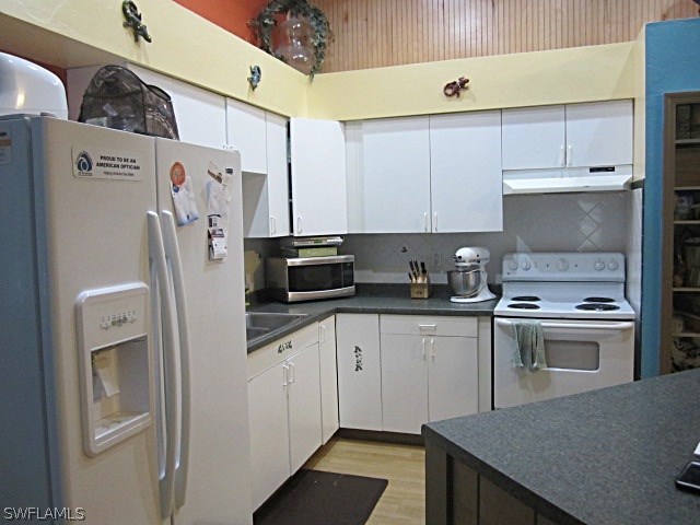 12931 Shawnee Road Fort Myers, FL 33913 - Photo 7 of 19 a kitchen with stainless steel appliances a stove a sink and a refrigerator