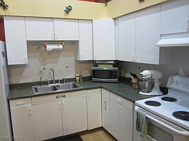 12931 Shawnee Road Fort Myers, FL 33913 - Photo 8 of 19 a kitchen with stainless steel appliances granite countertop a sink a stove and cabinets