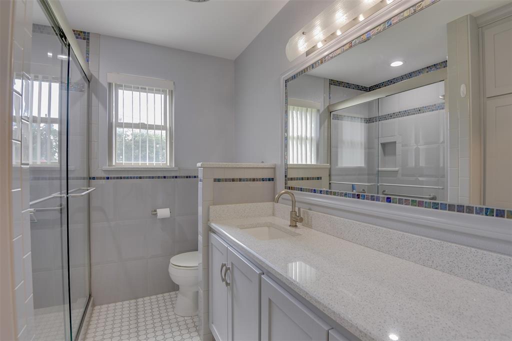 802 Cardinal Road Mansfield, TX 76063 - Photo 24 of 31 Full bath with vanity, healthy amount of natural light, a stall shower, light tile patterned floors, and tile walls