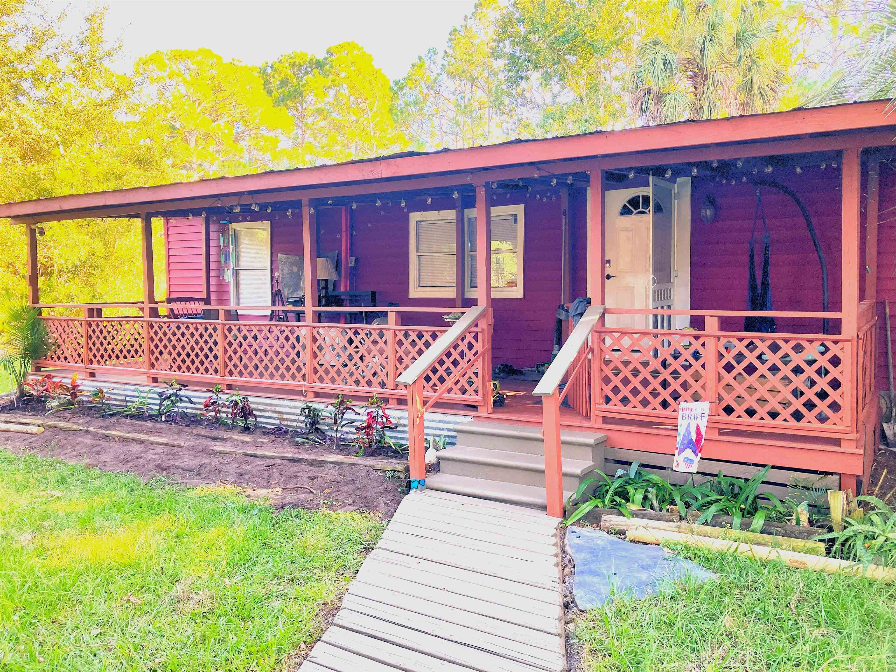 a view of a house with backyard and porch
