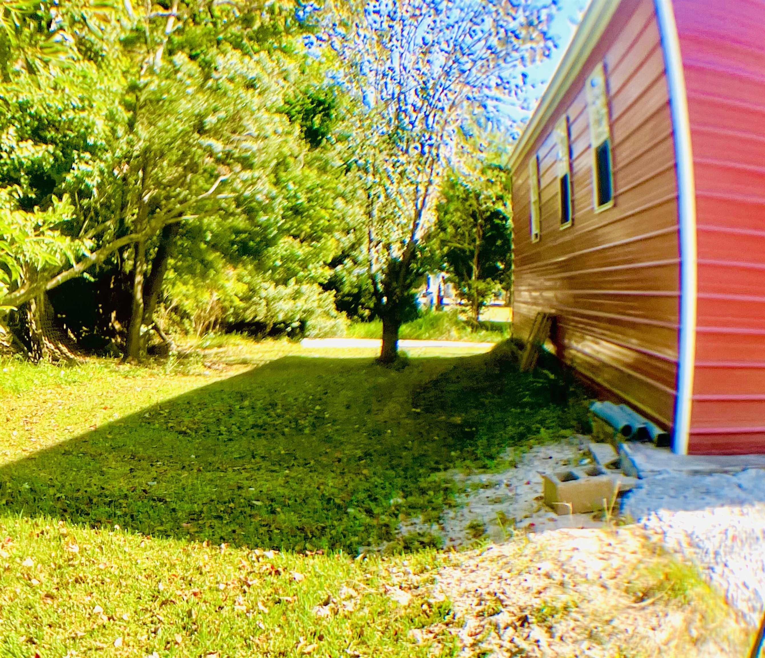 1611 Brian Way St. Augustine, FL 32084 - Photo 20 of 23 a view of a yard with plants and large trees