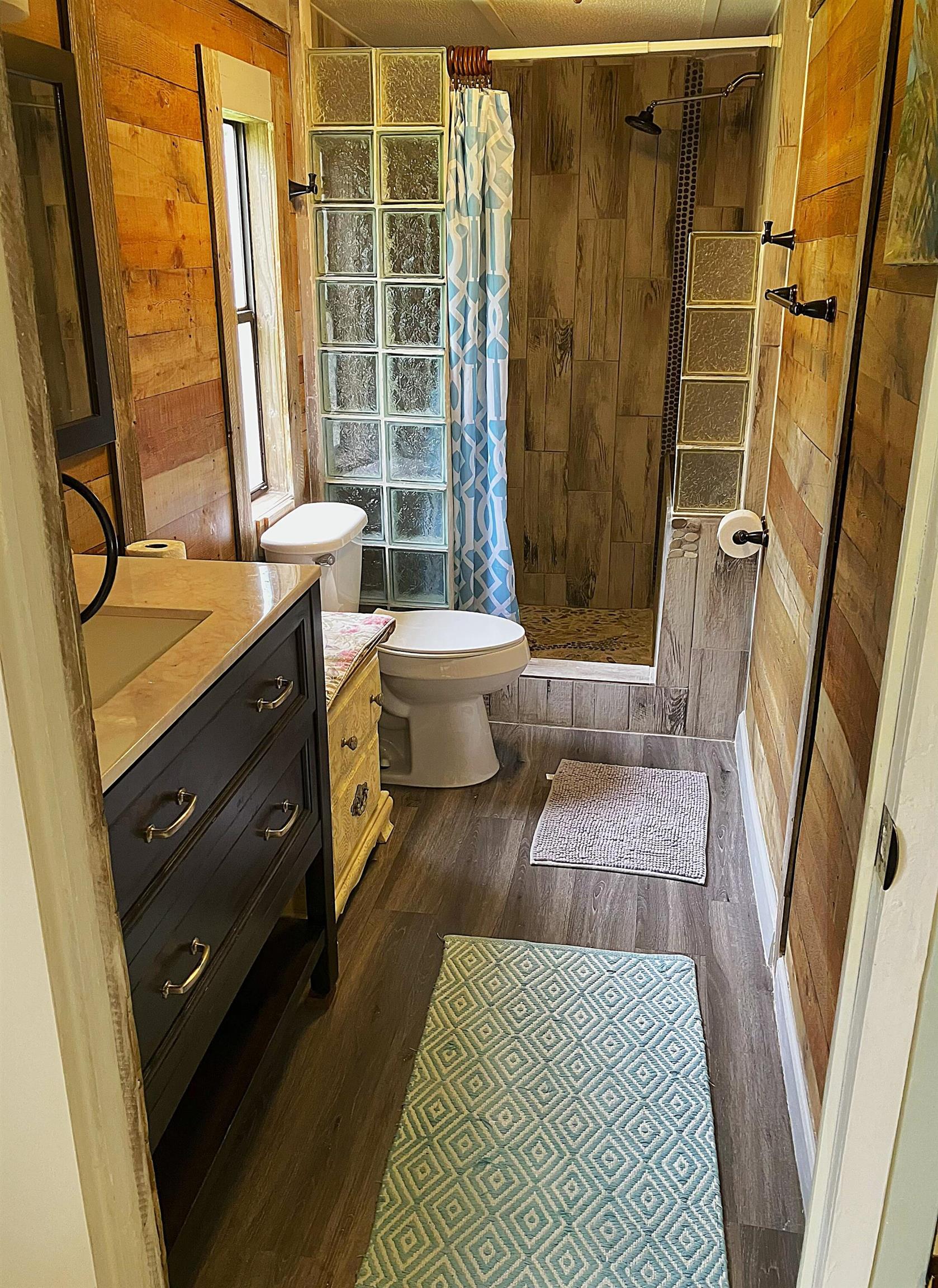 1611 Brian Way St. Augustine, FL 32084 - Photo 3 of 23 a bathroom with a double vanity sink toilet and shower