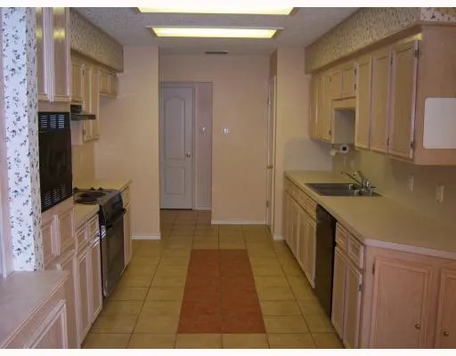 a kitchen with a sink and a refrigerator