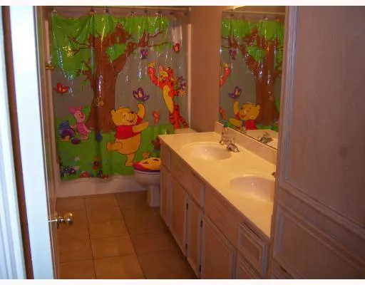 a bathroom with a sink mirror vanity and toilet