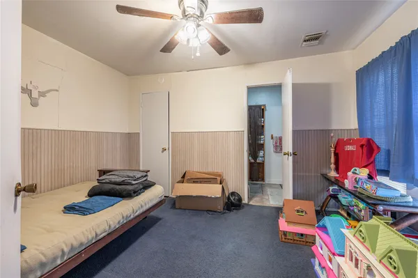 a bedroom with bed and a chandelier