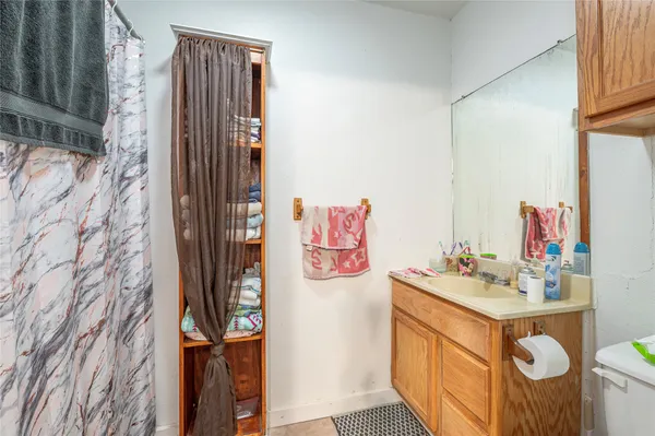 a bathroom with a sink mirror and vanity