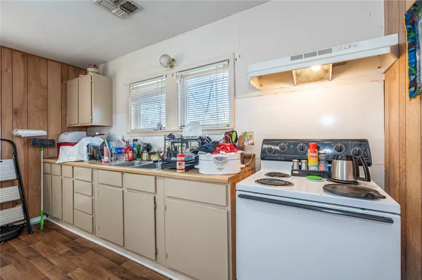 a kitchen with sink refrigerator and window