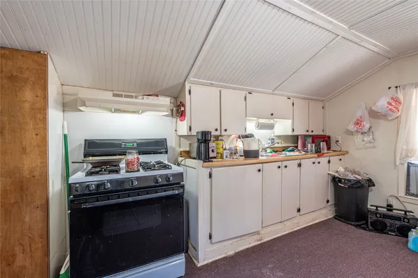 a kitchen with a stove and a refrigerator