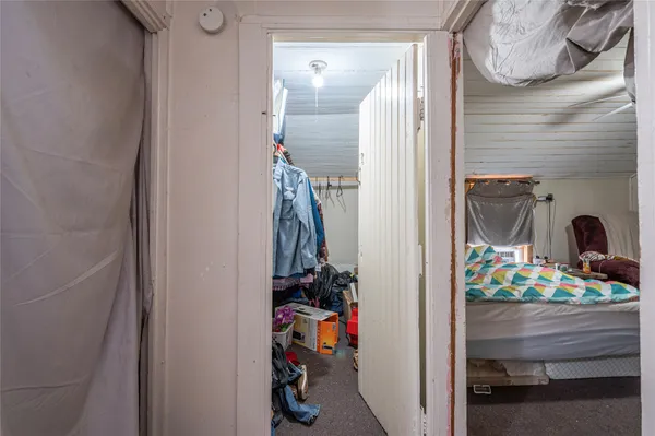 a bedroom with bed and a chandelier