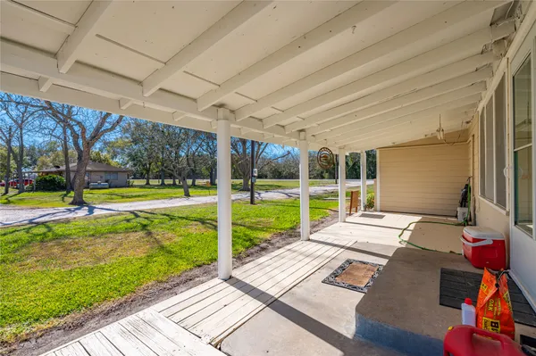 a view of a porch with furniture and garden