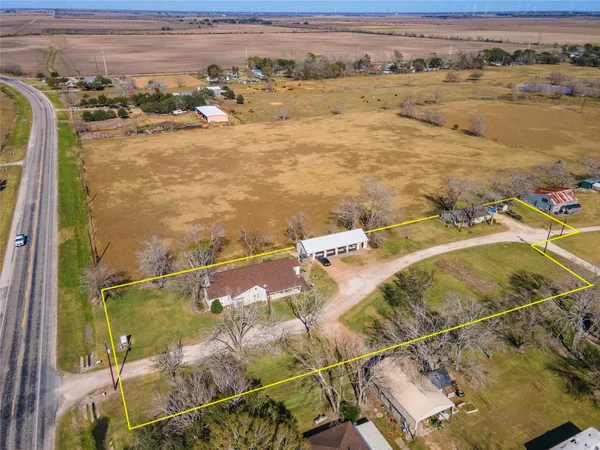 an aerial view of residential houses with outdoor space