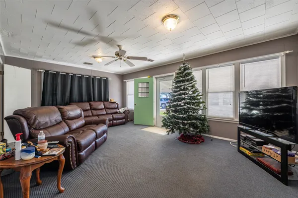 a living room with furniture gym equipment and a window