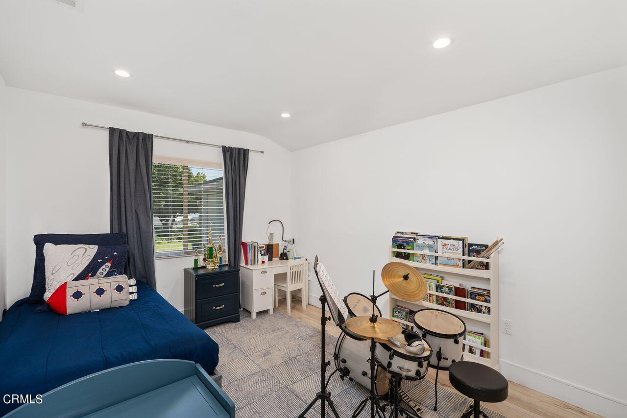 3875 Cartwright Street Pasadena, CA 91107 - Photo 15 of 25 a bedroom with furniture and a book shelf