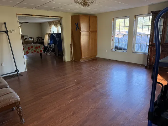 a view of a livingroom with hardwood floor and a window