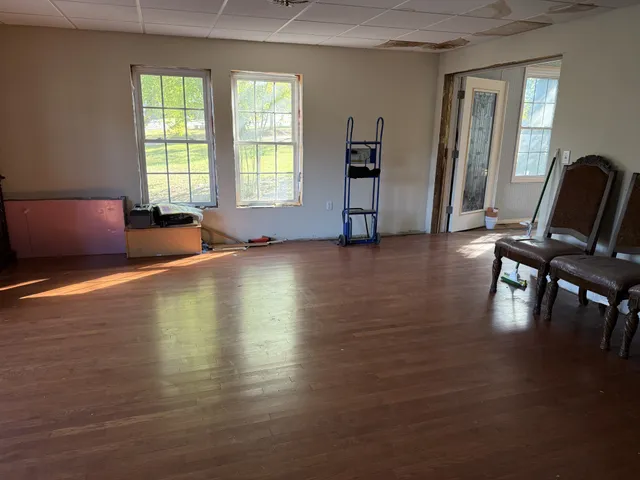 a view of a livingroom with furniture wooden floor and windows