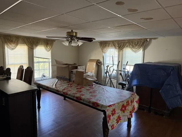 a dining table with chairs and window