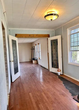 wooden floor in an empty room with a window