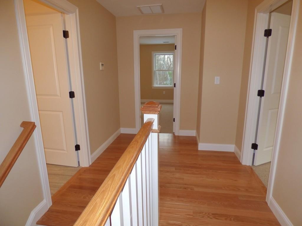 16 Kevin's Way, Unit 7 Scituate, MA 02066 - Photo 11 of 19 a view of a hallway with wooden floor and staircase