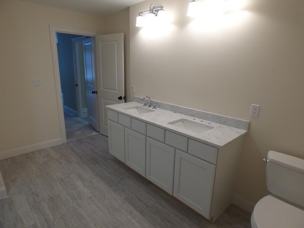 16 Kevin's Way, Unit 7 Scituate, MA 02066 - Photo 13 of 19 a bathroom with a sink and mirror with toilet