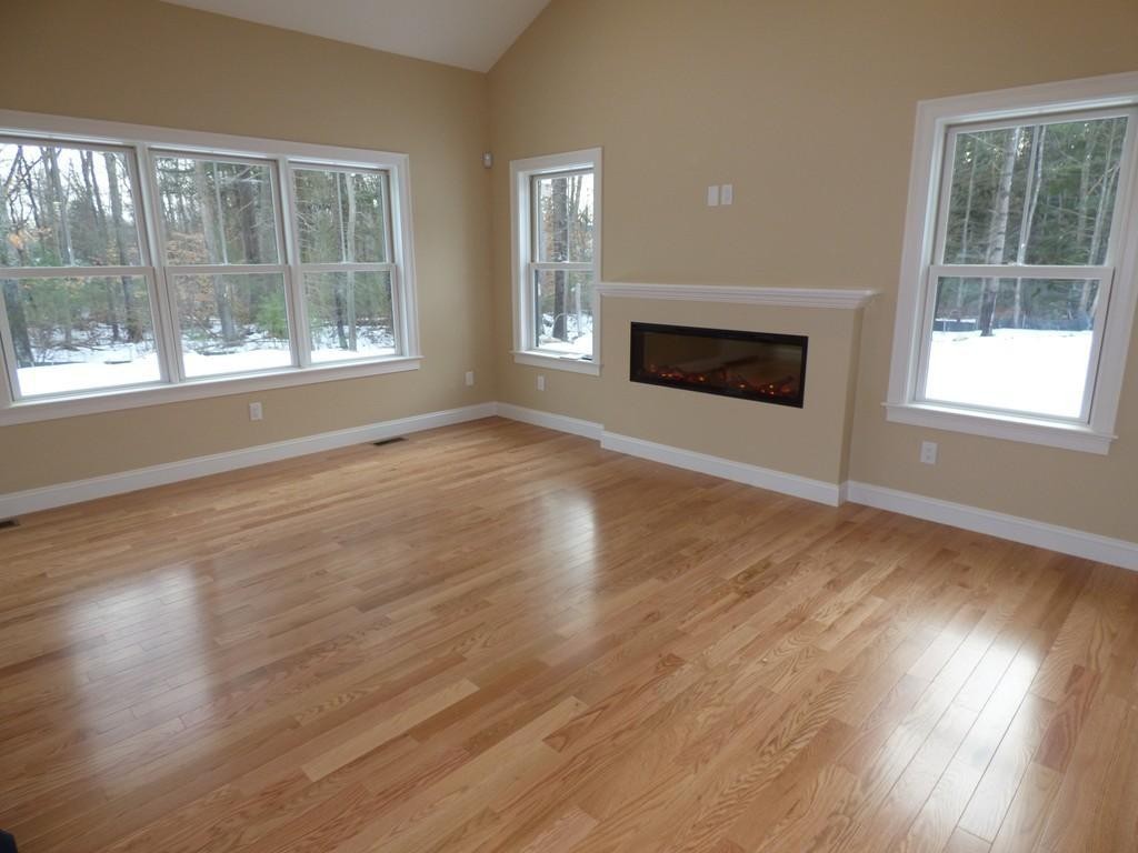 16 Kevin's Way, Unit 7 Scituate, MA 02066 - Photo 6 of 19 a view of an empty room with wooden floor and a window
