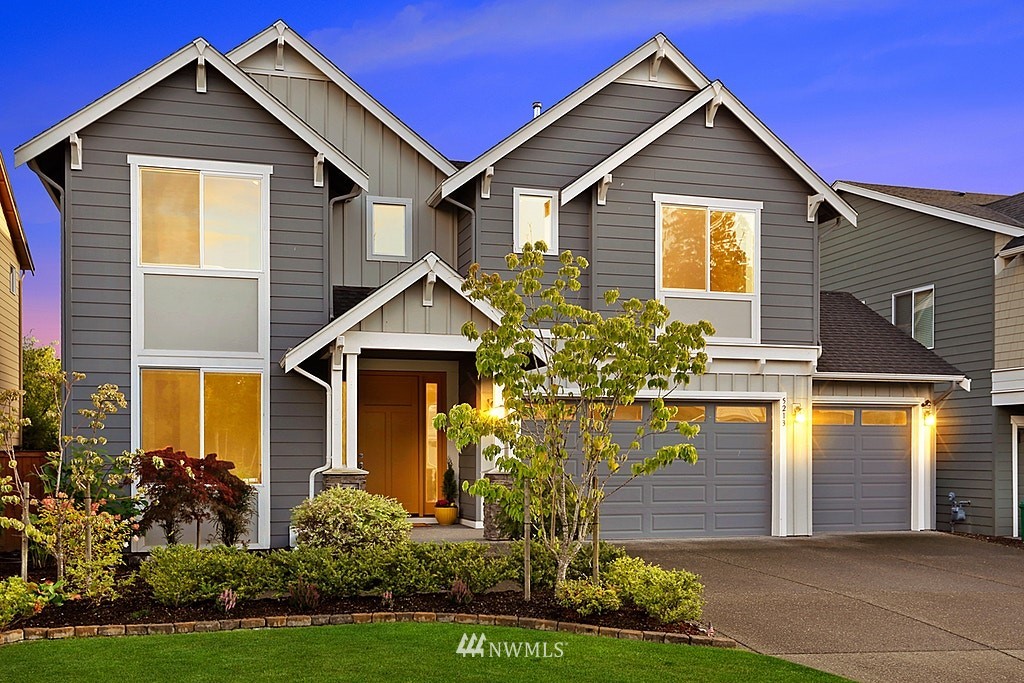 5213 Northeast 2nd Place Renton, WA 98059 - Photo 1 of 25 a front view of a house with a yard and trees