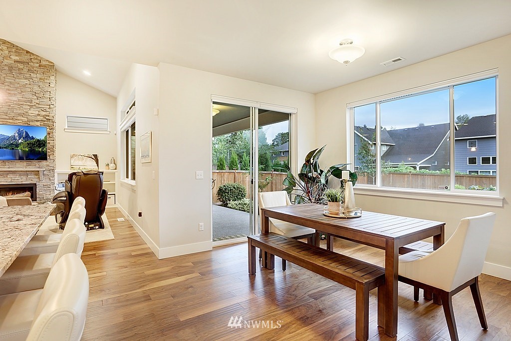 5213 Northeast 2nd Place Renton, WA 98059 - Photo 12 of 25 a view of a dining room with furniture and wooden floor
