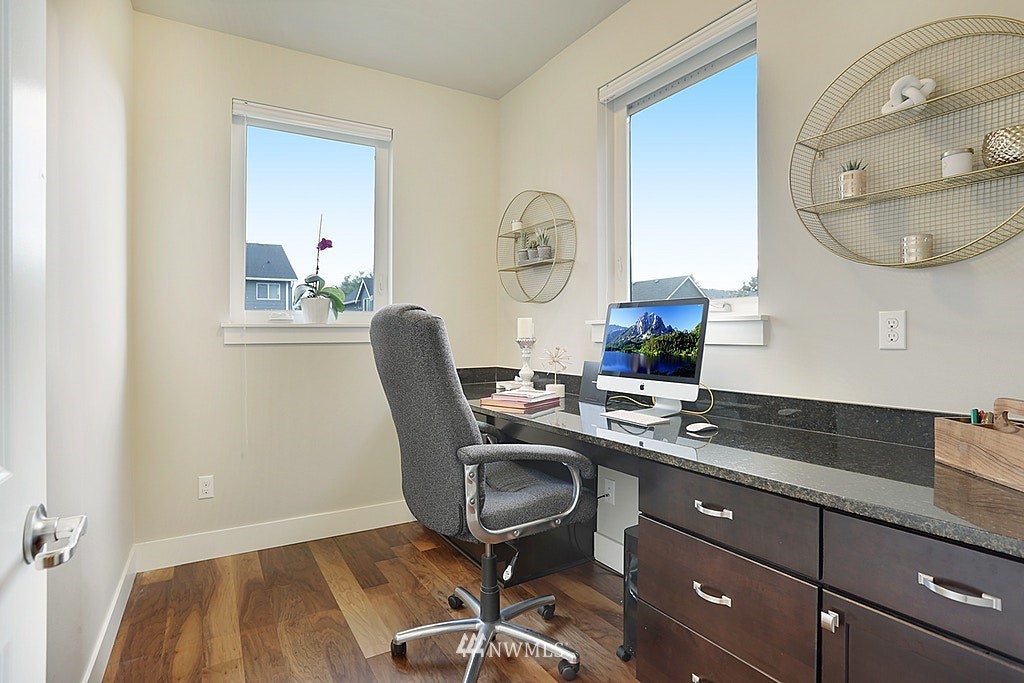 5213 Northeast 2nd Place Renton, WA 98059 - Photo 13 of 25 a view of a workspace room with wooden floor cabinet and mirror