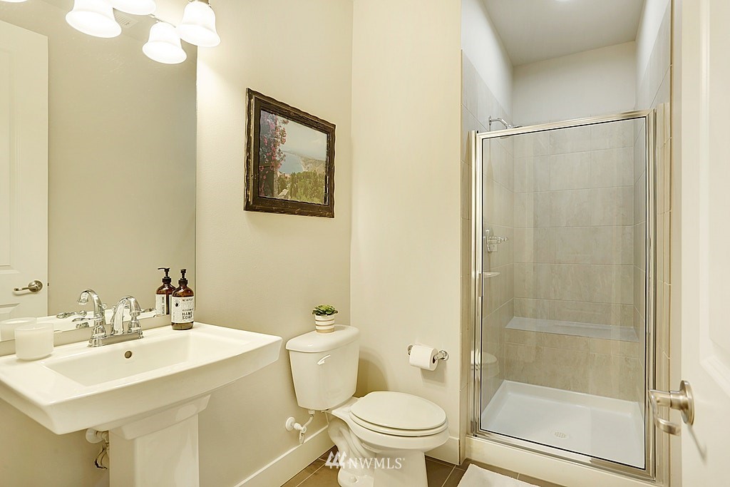 5213 Northeast 2nd Place Renton, WA 98059 - Photo 15 of 25 a bathroom with a sink mirror toilet and shower