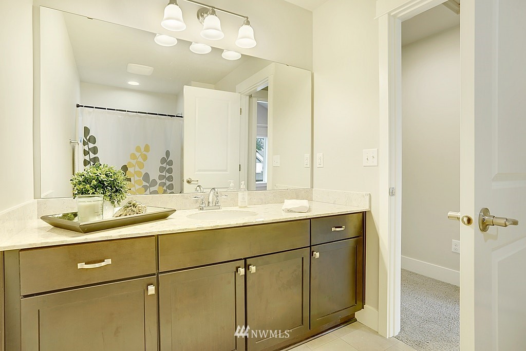 5213 Northeast 2nd Place Renton, WA 98059 - Photo 20 of 25 a bathroom with a sink and a mirror