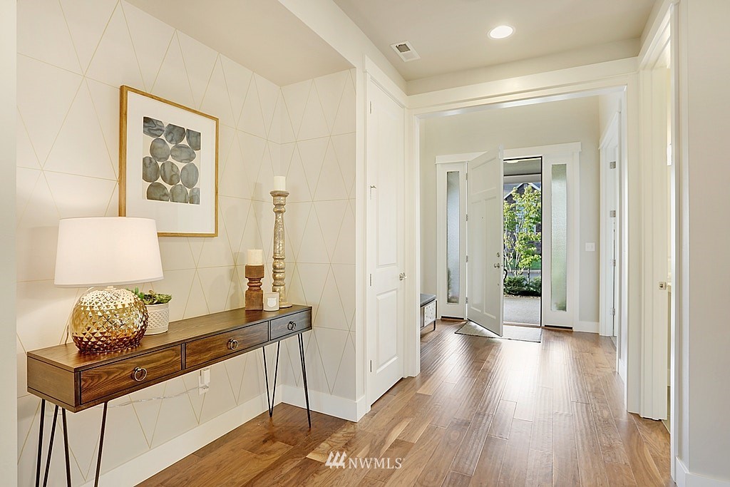 5213 Northeast 2nd Place Renton, WA 98059 - Photo 3 of 25 a hallway with front door wooden floor and windows