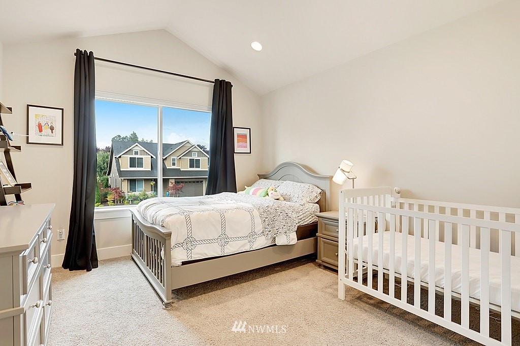 5213 Northeast 2nd Place Renton, WA 98059 - Photo 21 of 25 a bedroom with a bed with large window