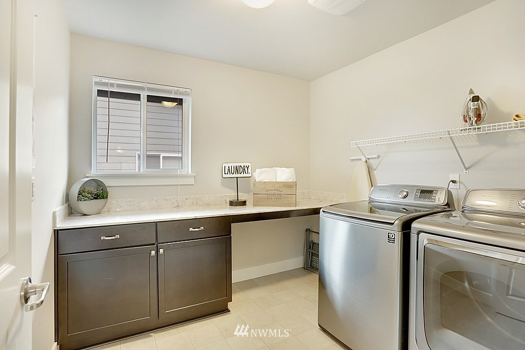 5213 Northeast 2nd Place Renton, WA 98059 - Photo 22 of 25 a kitchen with stainless steel appliances granite countertop a sink stove and cabinets