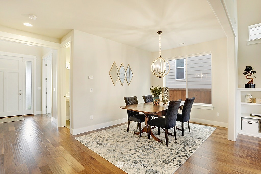 5213 Northeast 2nd Place Renton, WA 98059 - Photo 5 of 25 a view of a dining room with furniture window and wooden floor