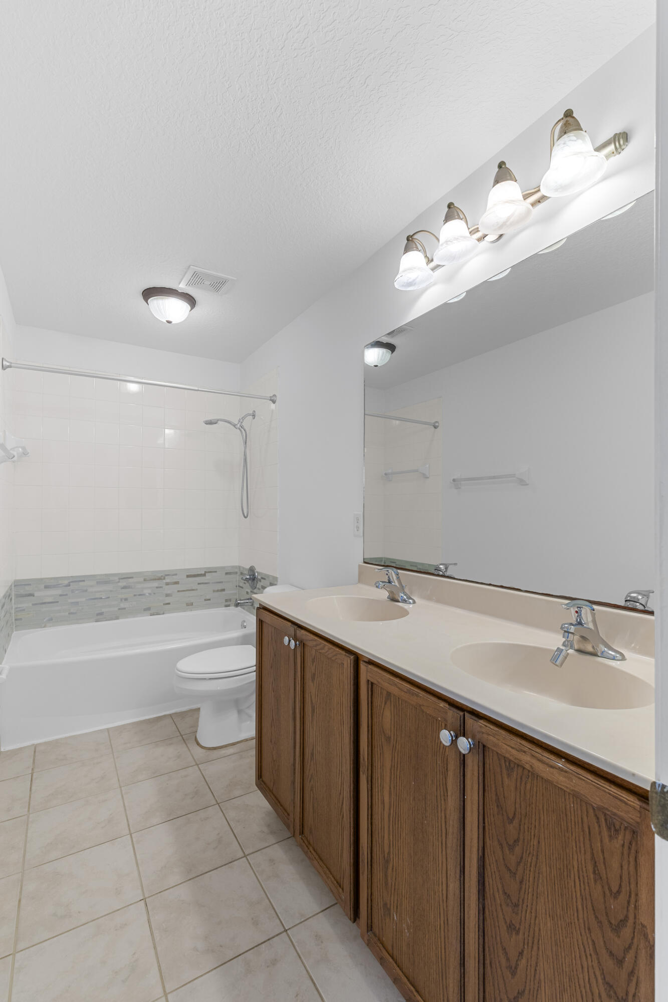 9107 Chambers Street, Unit 9107 Tamarac, FL 33321 - Photo 22 of 30 a bathroom with a sink vanity tub and a mirror