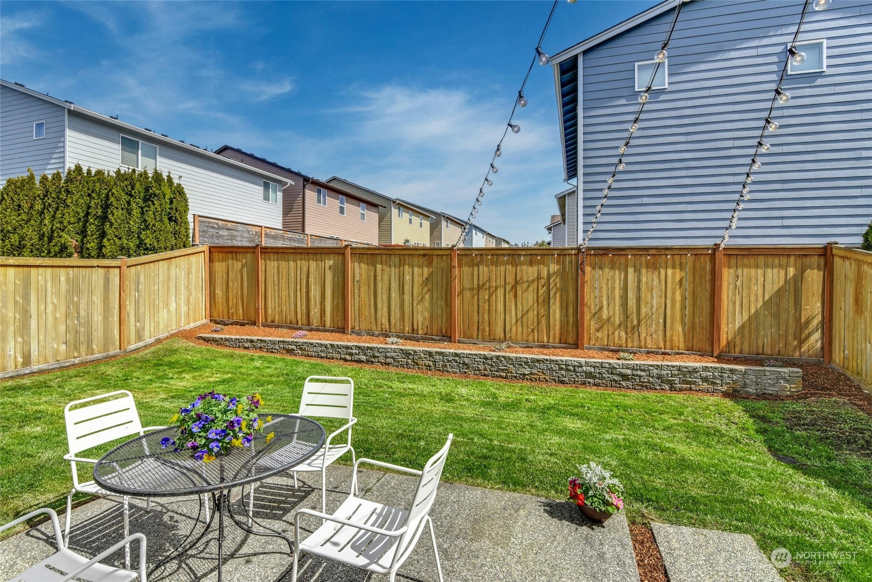 22313 35th Drive Southeast Bothell, WA 98021 - Photo 24 of 26 a view of a backyard with table and chairs with wooden fence