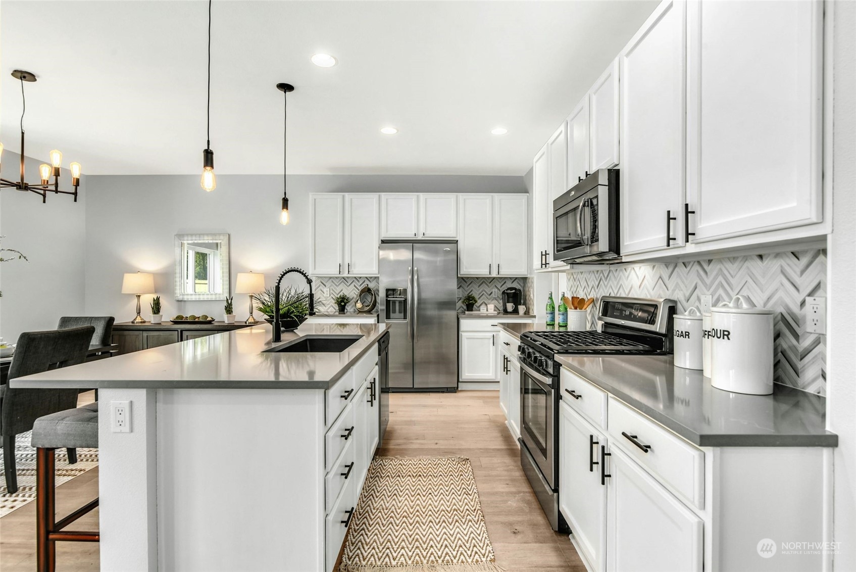 22313 35th Drive Southeast Bothell, WA 98021 - Photo 6 of 26 a kitchen with stainless steel appliances granite countertop a sink a stove and a refrigerator