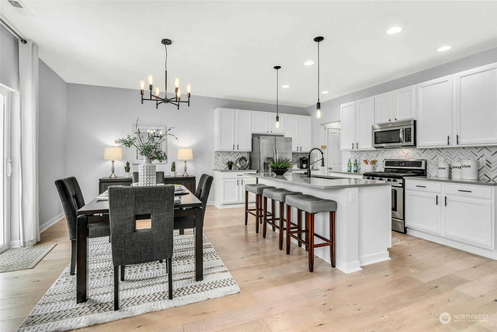 22313 35th Drive Southeast Bothell, WA 98021 - Photo 8 of 26 a kitchen with kitchen island a dining table and chairs
