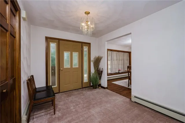 a view of a hallway with windows and entryway