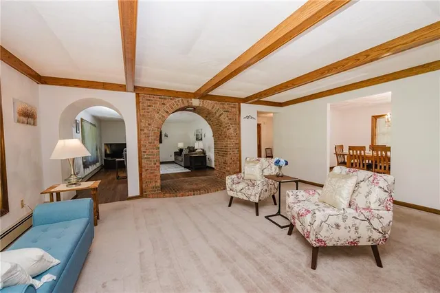 a living room with furniture a couch and wooden floor