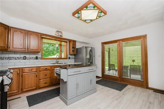 a kitchen with stainless steel appliances a stove sink and cabinets