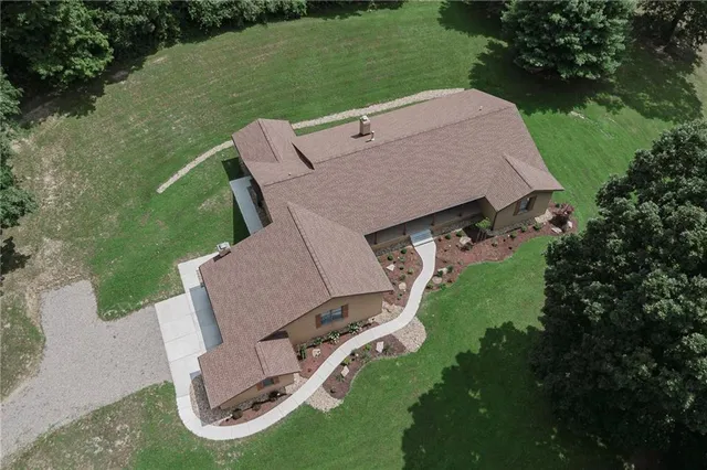an aerial view of a house with a yard table and chairs
