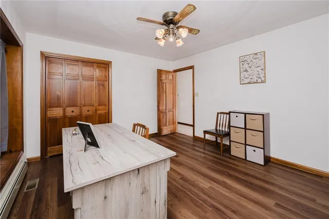 a view of a workspace with furniture and window