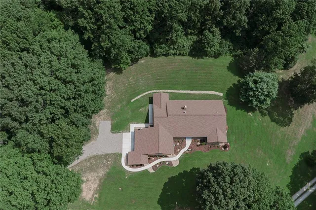 an aerial view of a house with a yard